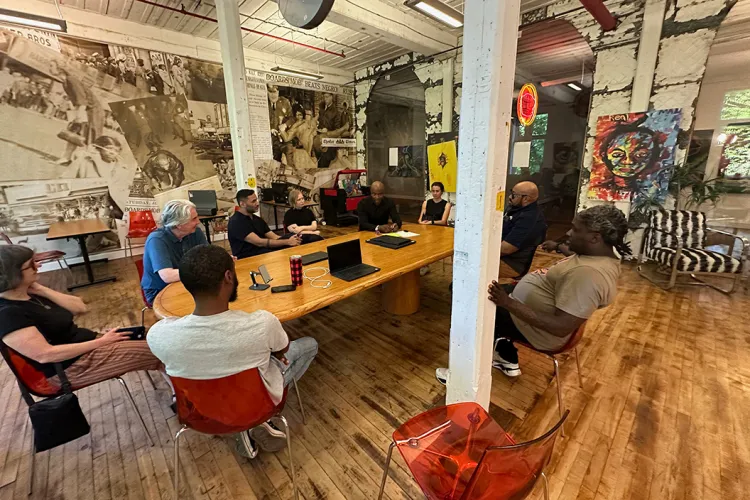 Group of people meet at table in Chester, Pa.