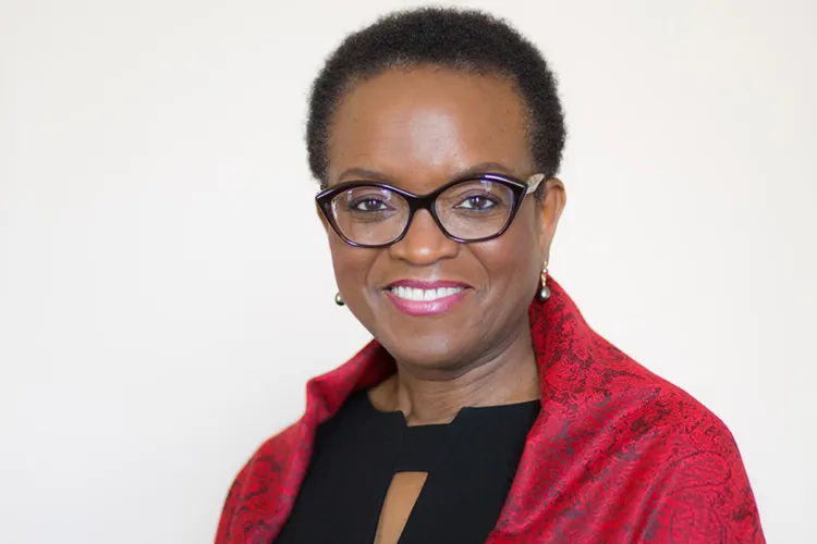 Valerie Smith wearing red jacket, smiling at camera