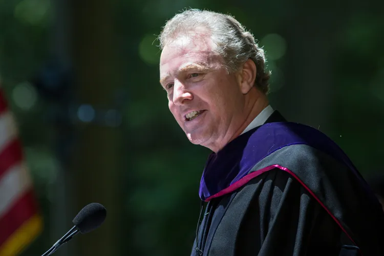 Chris Van Hollen in robes at podium during commencement