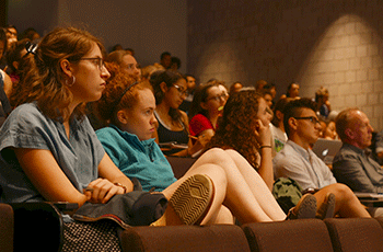 Students sit in an auditorium