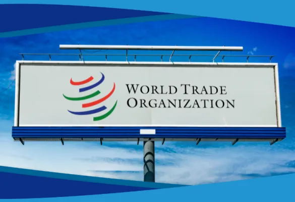 Image of a billboard with the text and logo of the World Trade Organization against a blue sky