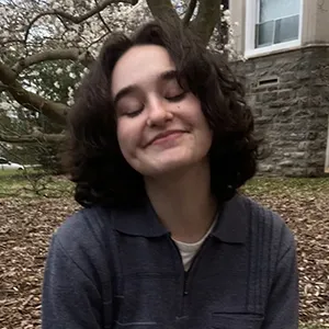 Julia Stern seated outdoors on campus