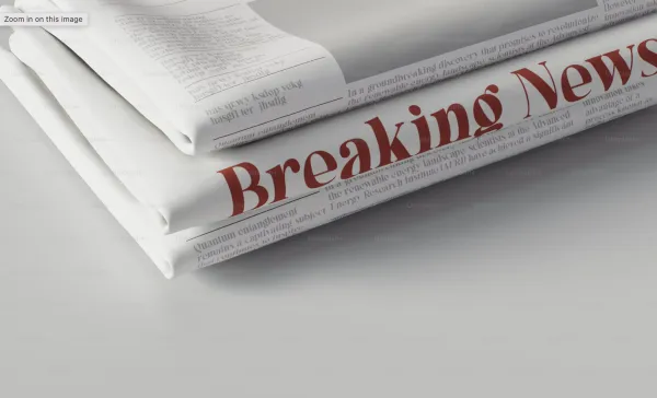 a newspaper that says "breaking news"