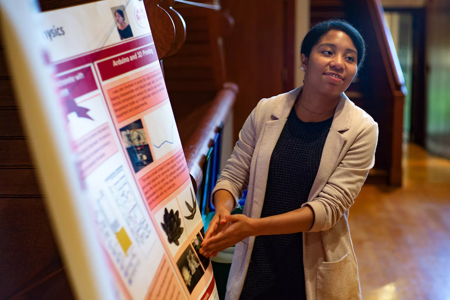 Student presents poster during session in Upper Tarble