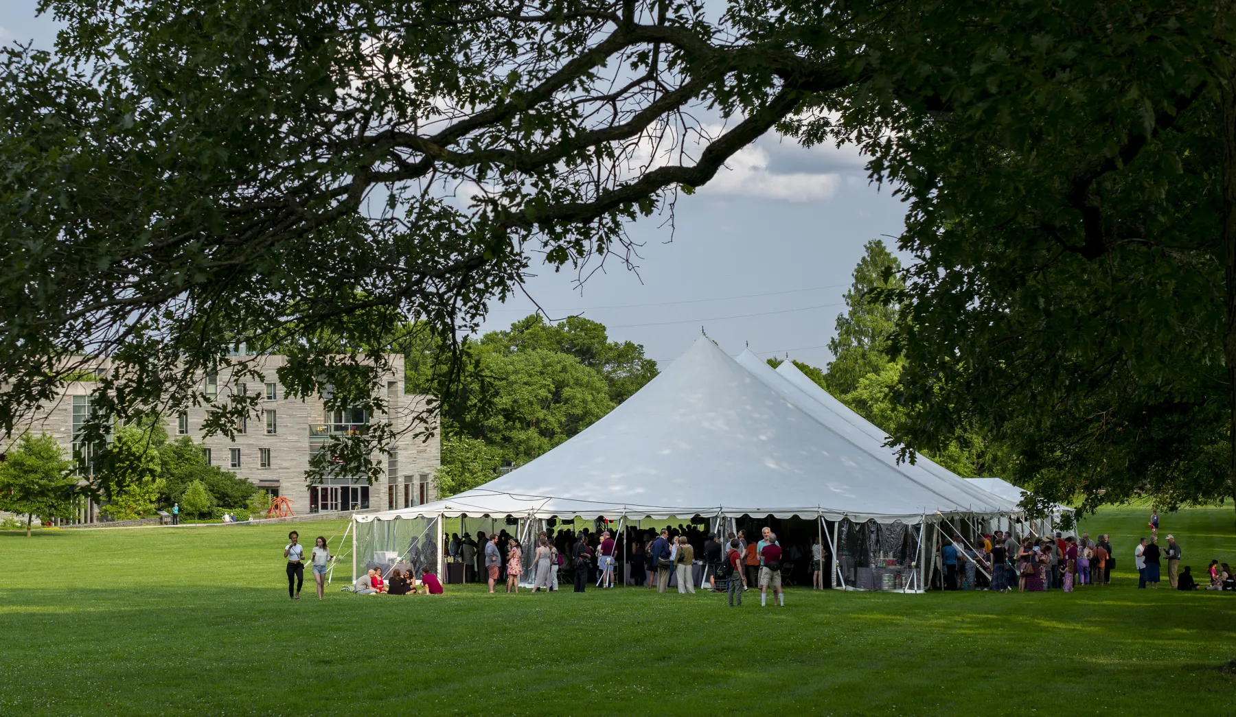 Alumni under white tent on Mertz lawn