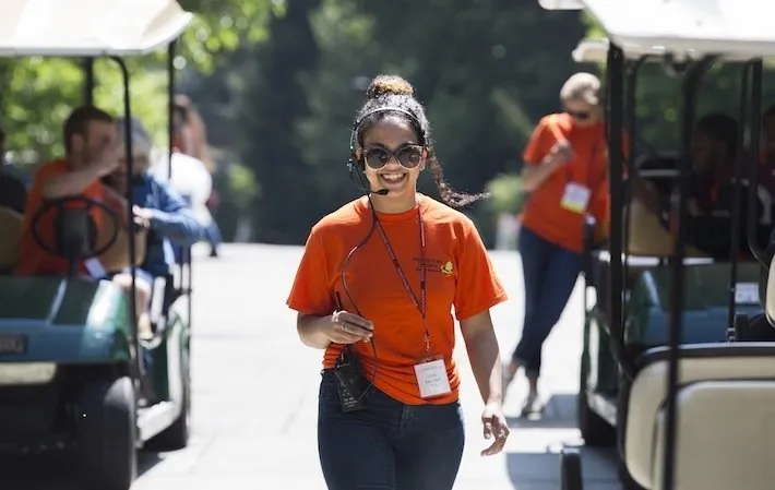 Student workers drive golf carts during Alumni Weekend