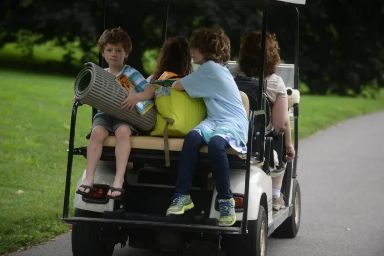 Young visitors on a golf cart