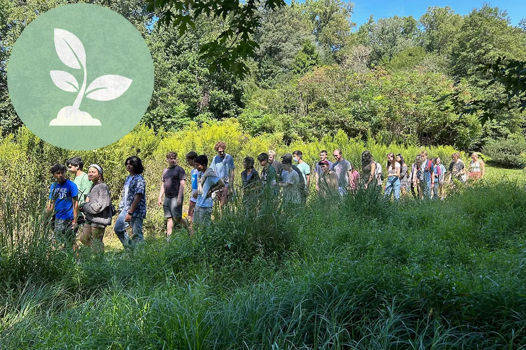 Student walk outdoors in Crum woods. Green circle with plant logo in top left corner.