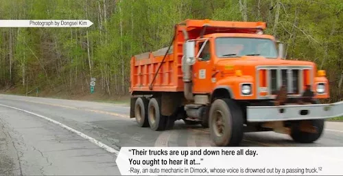 Truck driving on a rural road.