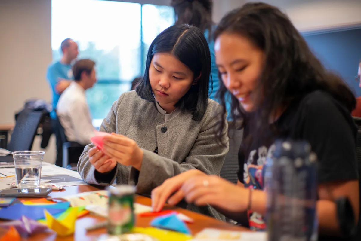 Two students work on origami during Garnet Weekend 2018