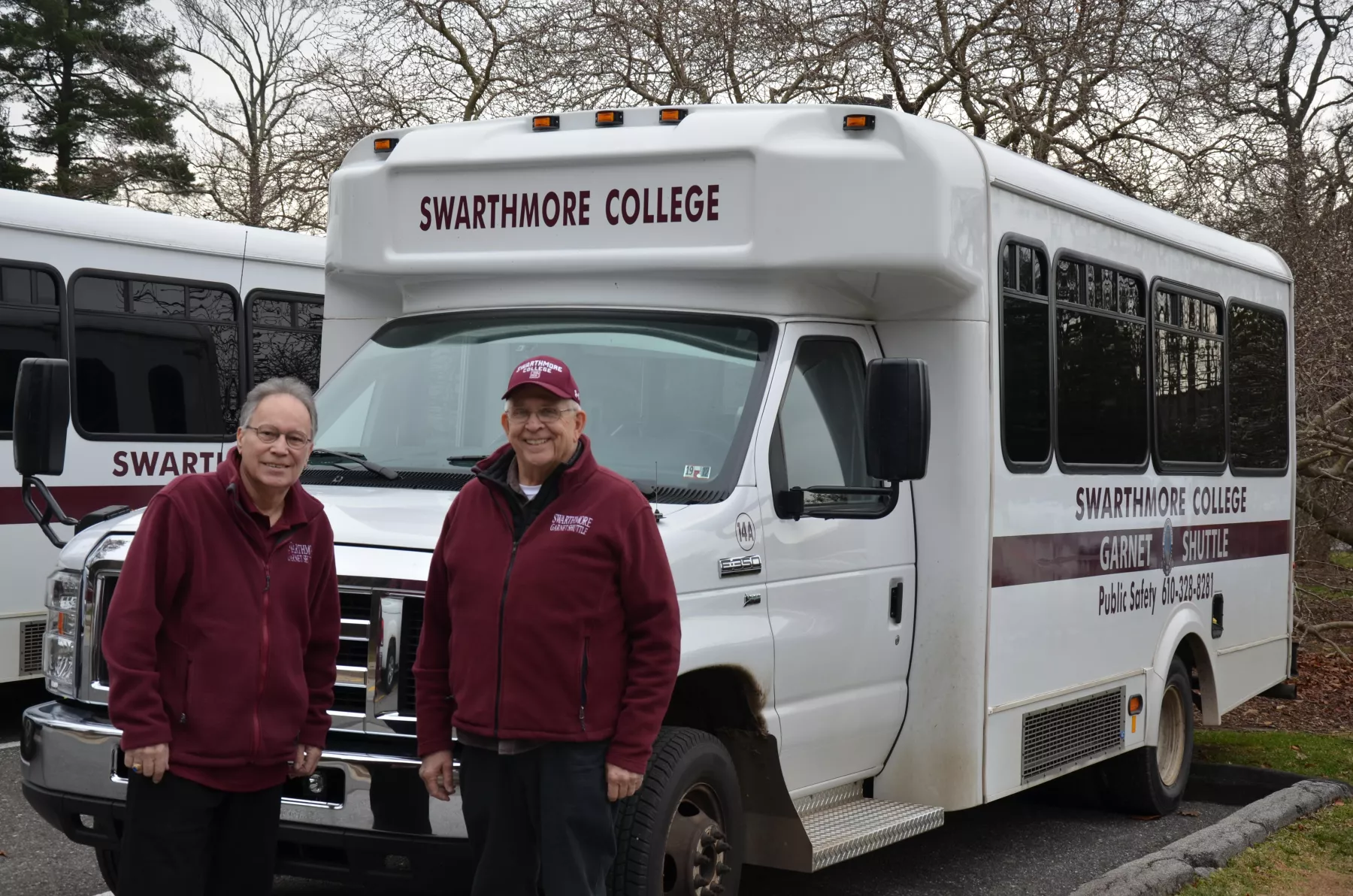 Two men in front of shuttle van