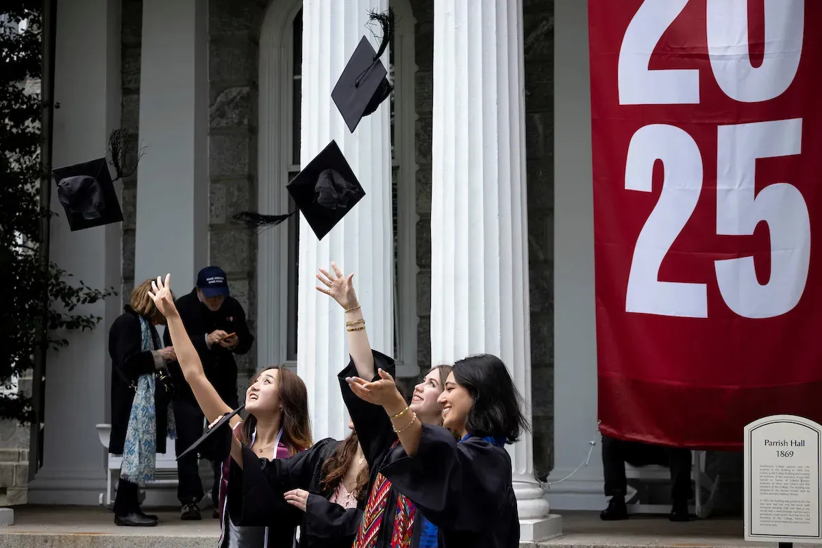 graduates tossing their caps