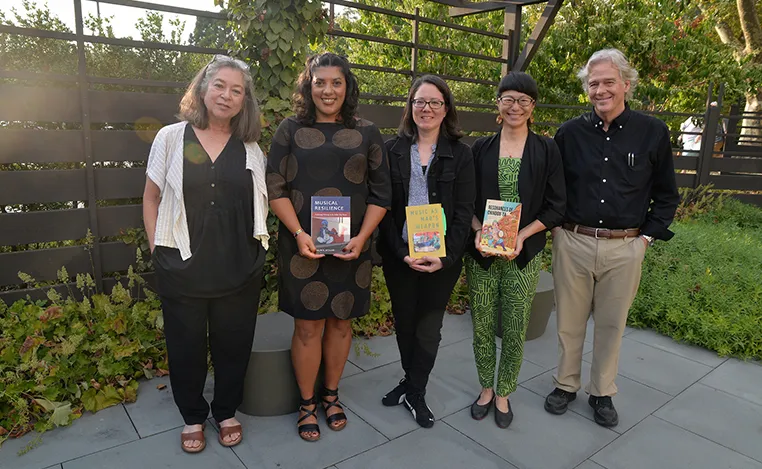 Faculty authors holding books at an Aydelotte book launch event