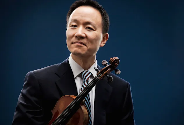 David Kim holding his violin under his arm