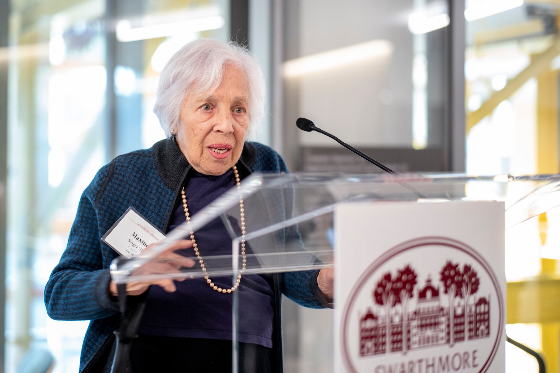 Maxine frank singer at podium during dedication of her eponymous building
