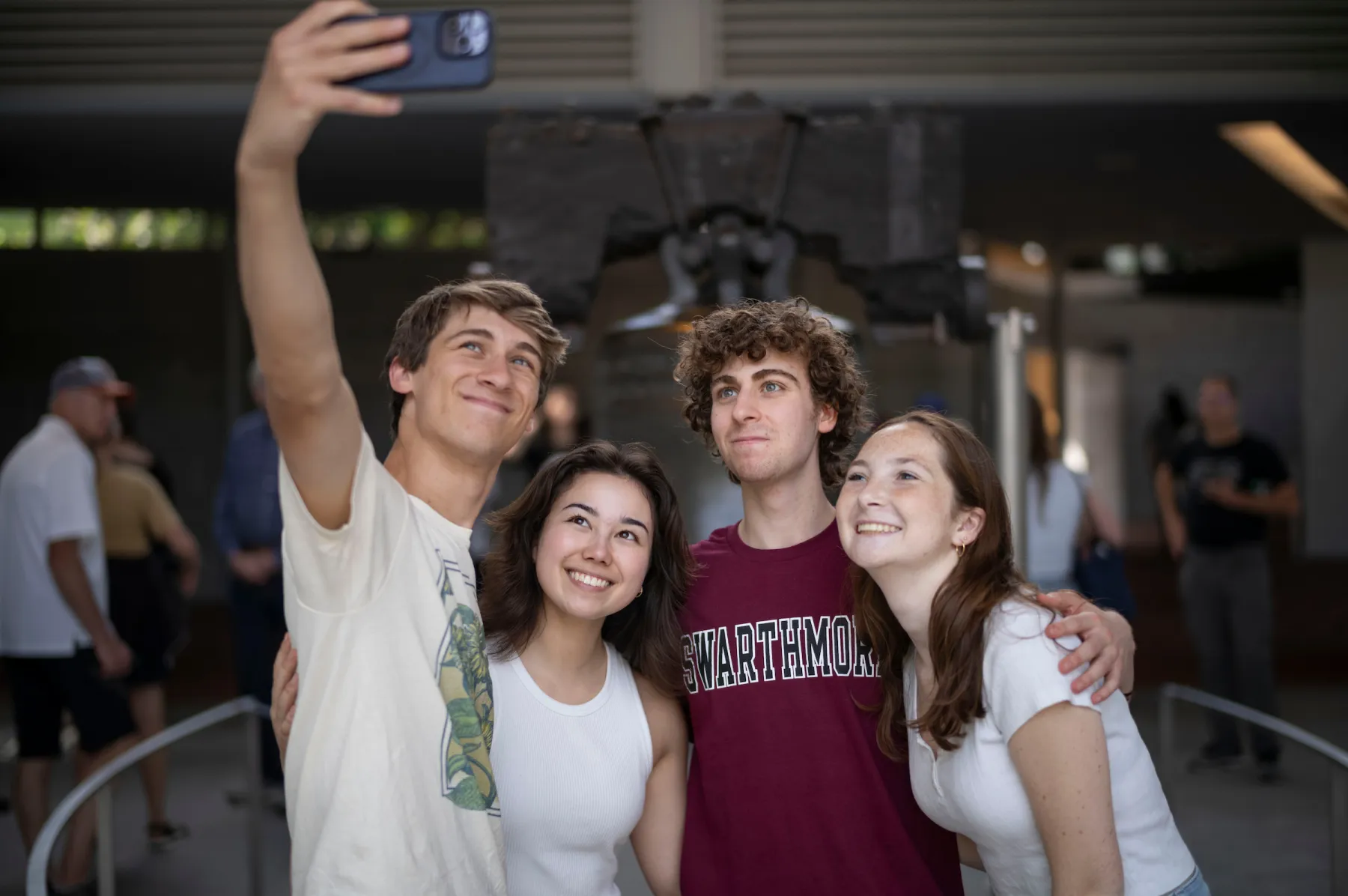 Four students take a selfie in front of the Liberty Bell in Philadelphia.