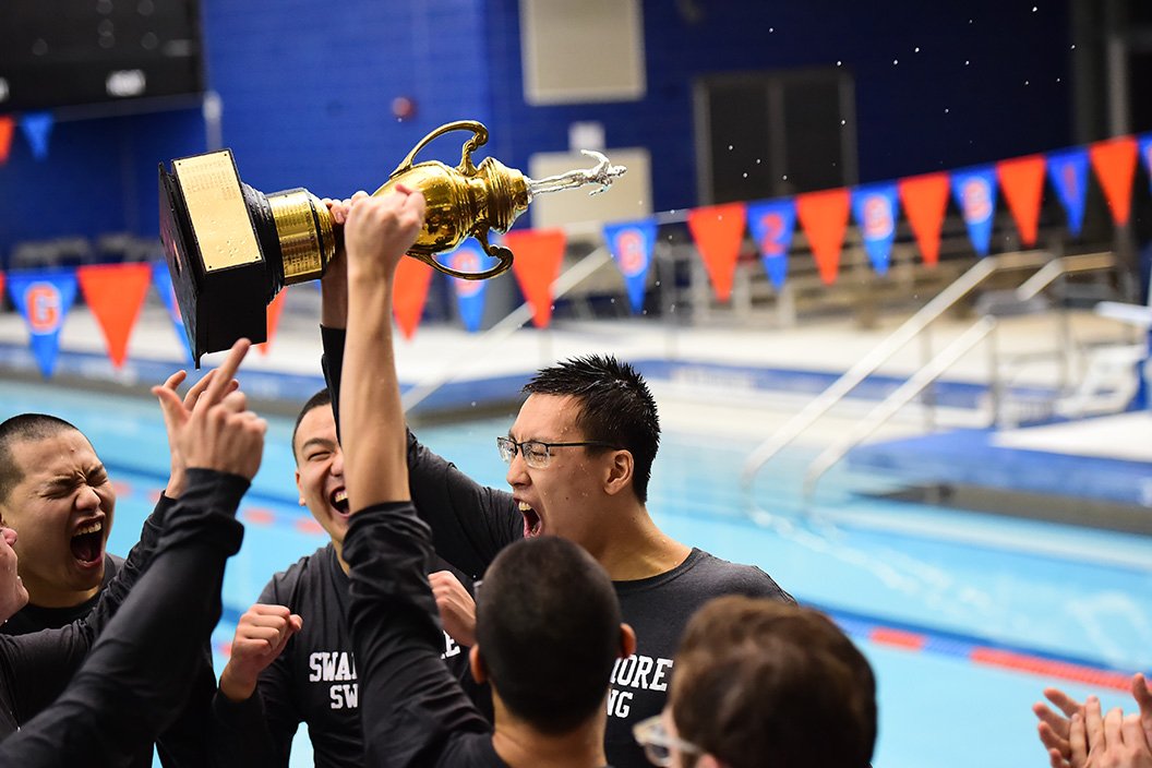 Members of swim team with trophy