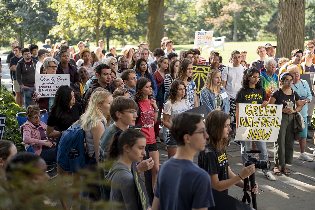 Students, faculty, staff and community members stand on Magill Walk