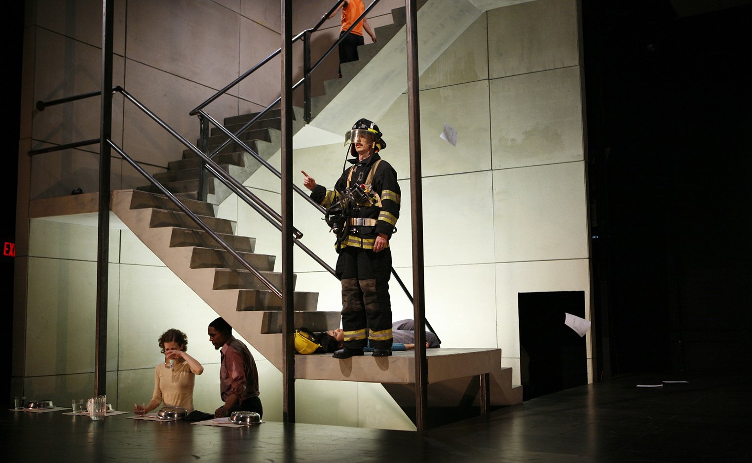 Person dressed as firefighter stands in stairwell