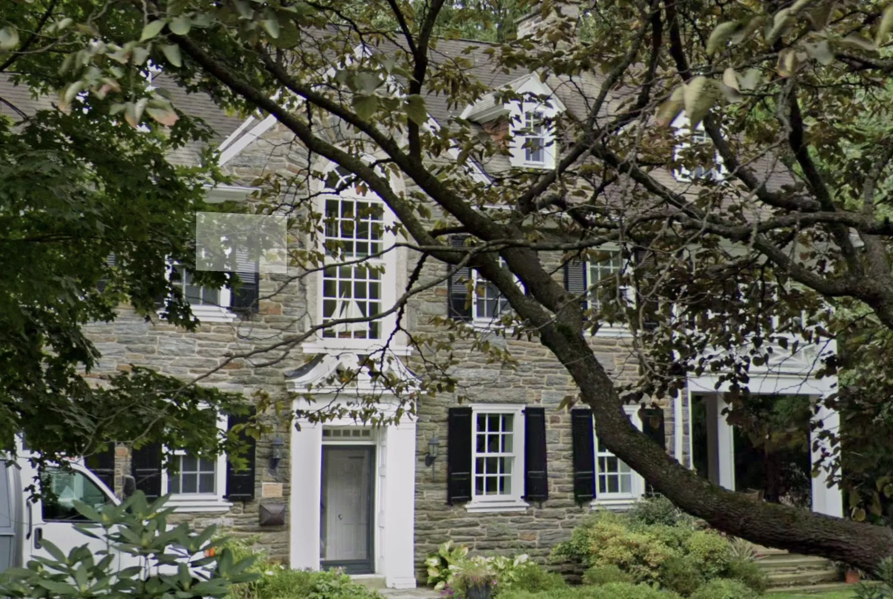 stone house with black shutters