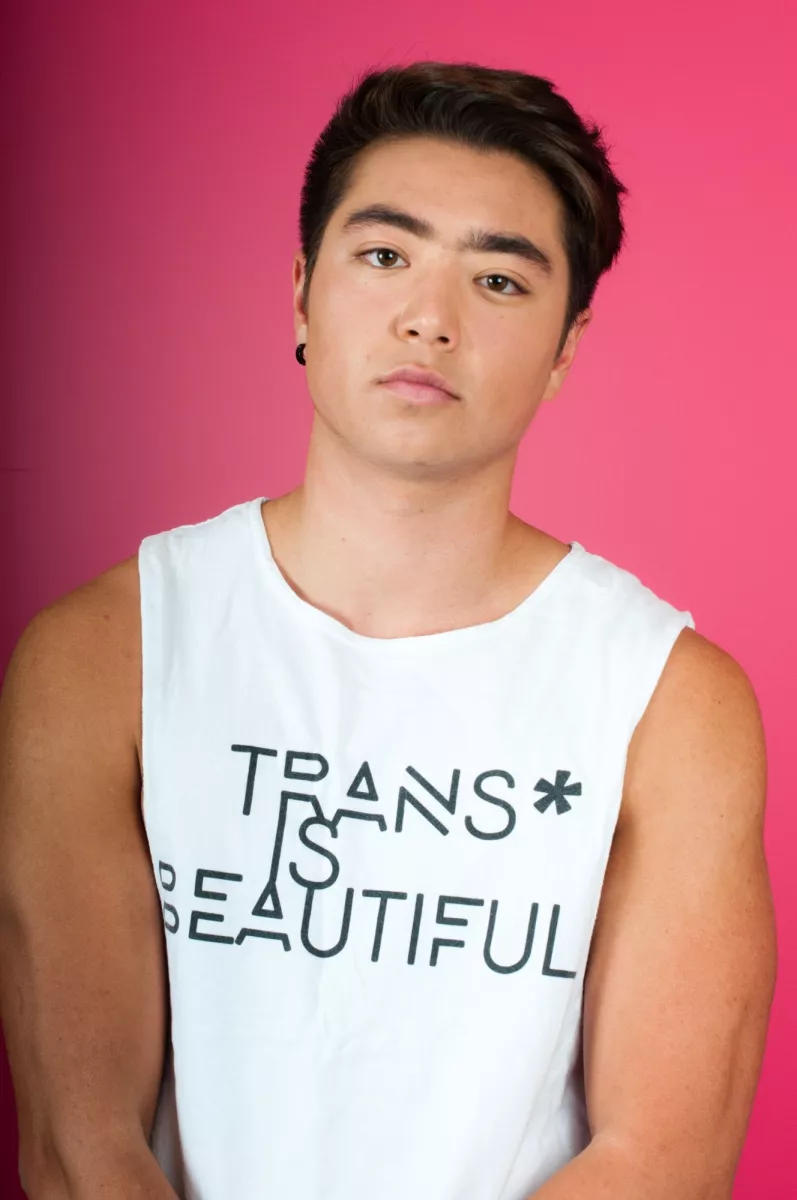 Photo of Schuyler Bailar wearing a "Trans* is Beautiful" tank top.