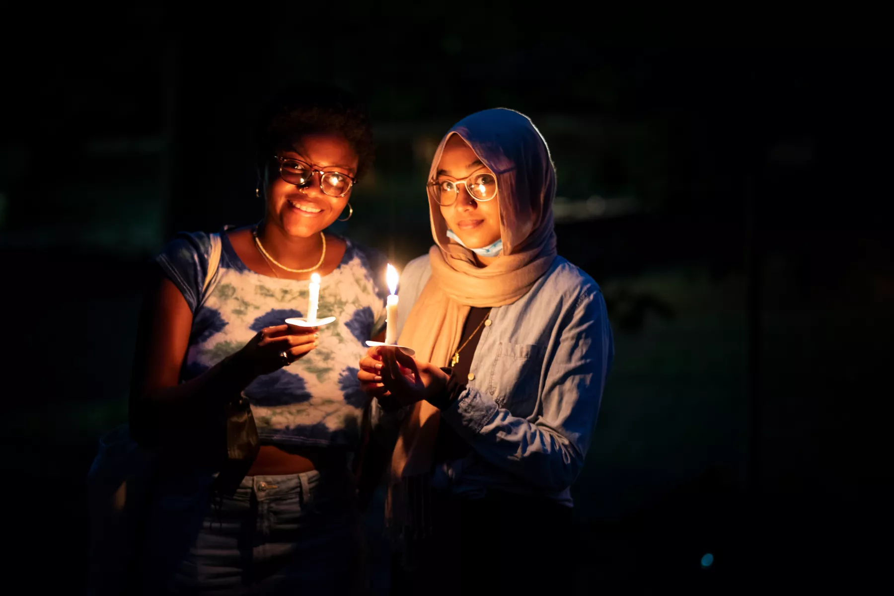 two transfer students holding candles at collection