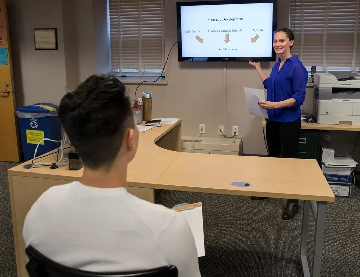 Teacher presenting to a student