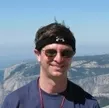 Professor Rablen standing with arid mountain range in the background