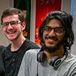 Two male students smiling at Percepticon exhibit