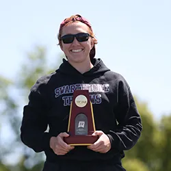 Adria Retter at podium with trophy