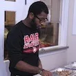 Ryan Greenlaw '15 prepares to serve food at the annual SASS Thanksgiving Dinner.