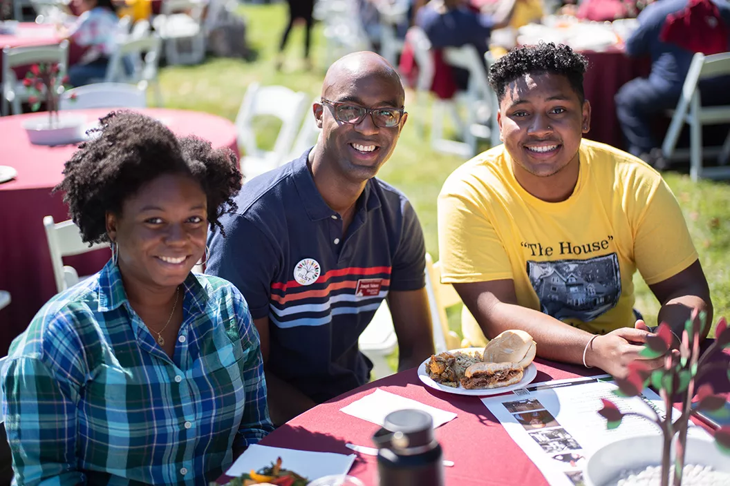 Students sit with professor at Swarthmore Fall Gathering celebration of Black Excellence