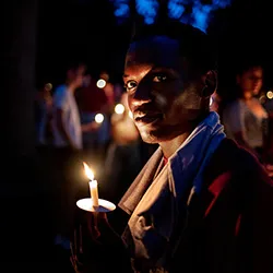 Student holds candle at First Collection