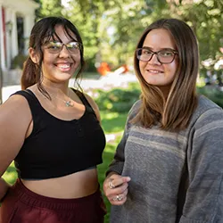 Melody Herrera-Garcia ’26 (left) and Danika Grieser ’26 on Parrish lawn