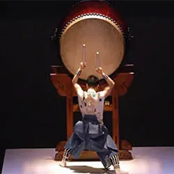 Taiko drummer performs on stage