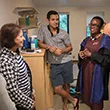 President Valerie Smith talks to a student and his family in his dorm on move-in day